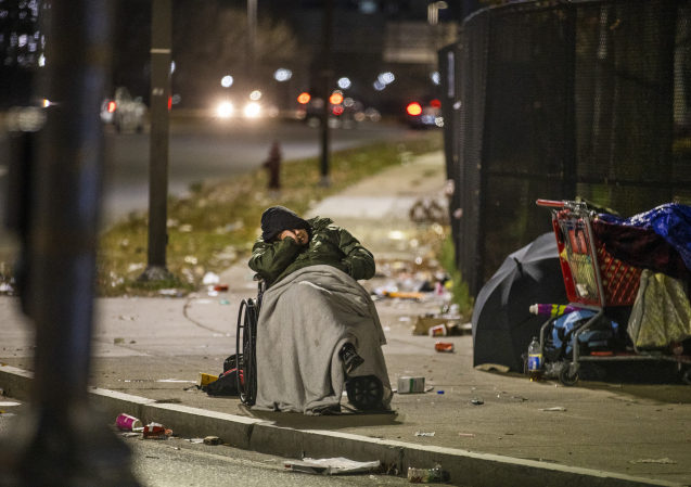 BOSTON, MA - NOVEMBER 17: A homeless man in a wheelchair sleeps on Massachusetts Avenue at 6AM on Nov. 17, 2020. (Photo by Stan Grossfeld/The Boston Globe via Getty Images)